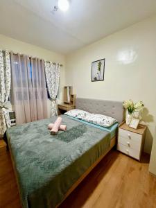 a bedroom with a bed with a pink stuffed animal on it at Te Haven in Davao City