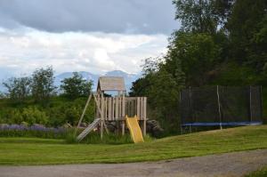 a playground in a park with a slide at Lysø naturcamping og rorbuer in Averoy