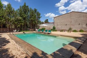 a swimming pool in the backyard of a house at Masia del siglo xvi in Vallbona