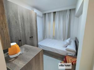 a small room with a bed and a wooden cabinet at new Villa117 in Cairo +11 photos