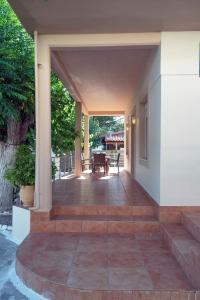 an outdoor patio with stairs leading to a house at Seaside Plitra Paradiso - Steps from the Beach in Plytra
