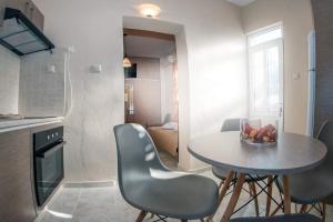 a kitchen with a table and chairs in a room at Seaside Plitra Paradiso - Steps from the Beach in Plytra +20 photos