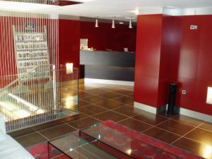 a lobby with red walls and a glass floor at Hotel Villa de Barajas in Madrid