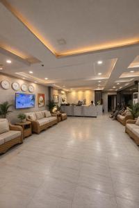 a large lobby with couches and tables in a building at Red Coco Inn de Boracay in Boracay