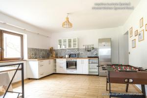 a kitchen with white cabinets and a table in it at Pokoje u Kamińskich 26E in Zakopane +61 photos