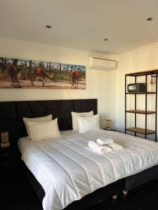 a bedroom with a large bed with two towels on it at Les Villas du Douar in Azib Oulad Lâdem +31 photos