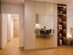 a room with a large glass partition with a table at Ceglana Apart 01A in Katowice