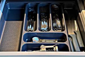 a drawer with utensils in it with a gun at Storm Villas in Sturmai +20 photos