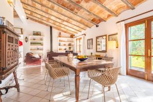 a kitchen with a wooden table and chairs at Finca Binifarda by Mallorca House Rent in Felanitx