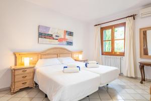 a bedroom with two beds and a window at Finca Binifarda by Mallorca House Rent in Felanitx