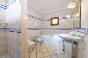 a bathroom with a sink and a toilet and a tub at Finca Binifarda by Mallorca House Rent in Felanitx +33 photos