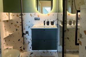 a bathroom with a sink and a mirror at Storm Villas in Sturmai