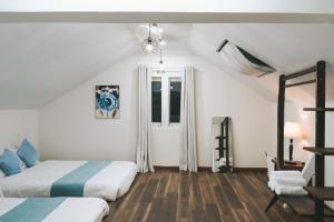 a bedroom with two beds and a window at StayDalat in Ấp Ða Lợi