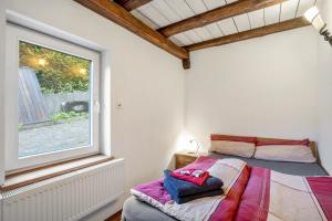 a bedroom with a bed and a window at Ferienresidenz Villa Kunterbunt in Warstein