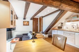 a kitchen and living room with a couch and a table at Ferienresidenz Villa Kunterbunt in Warstein