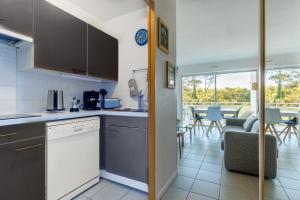 a kitchen and living room with a couch and a table at Entre Foret et Ocean in Moliets-et-Maa