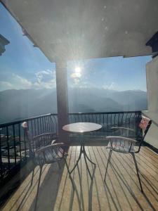 a table and chairs on a balcony with a view at Liberty Sapa Hotel in Sapa