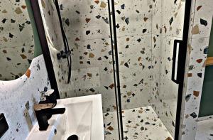 a bathroom with a rock wall with a sink at Storm Villas in Sturmai