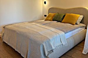 a bed with a blue blanket on it in a room at Storm Villas in Sturmai