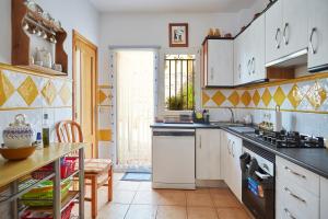 a kitchen with a sink and a stove at Casa Emilia in Baeza +32 photos