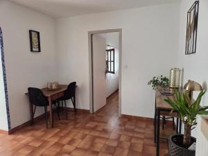 a dining room with a table and a table and chairs at Aurelia Verdon in Angles