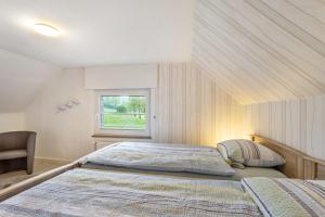 a bedroom with two beds and a window at Ferienwohnung Gerke in Warstein