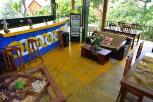 a living room with a couch and a bar at Hill Forest Cottage in Ella