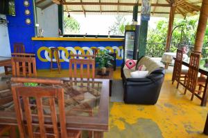 a room with a table and chairs and a couch at Hill Forest Cottage in Ella