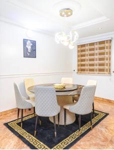 a dining room with a table and chairs at The 4 Kays Apartment - One Bedroom in Agege