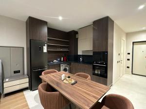 a kitchen with a wooden table and some brown cabinets at Sea Breeze in Baku