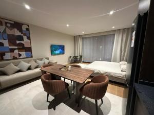 a living room with a table and a couch at Sea Breeze in Baku +8 photos