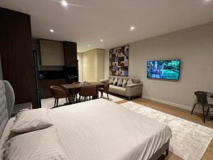 a bedroom with a bed and a table and a couch at Sea Breeze in Baku