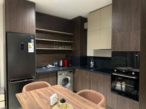 a kitchen with a table with chairs and a refrigerator at Sea Breeze in Baku