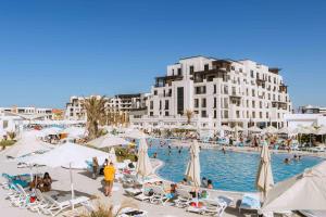 a resort with a swimming pool and a large building at Sea Breeze in Baku