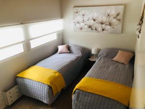 two beds sitting next to each other in a bedroom at The Zen Den Rokua in Utajärvi