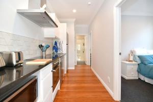 a kitchen with a sink and a counter top at The Weiti Waterfront in Whangaparaoa