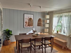 a dining room with a table and chairs at Apartment, Rekkedal Gjestegard - Sæbø in Ørsta