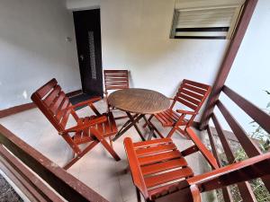 a table and chairs on a balcony with a table at Gergócs Vendégház in Őriszentpéter +3 photos