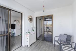 a living room with a table and a chair at Rainbow Amadores in Mogán