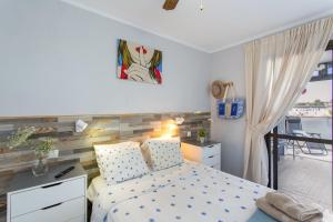 a small bedroom with a bed and a balcony at Rainbow Amadores in Mogán +18 photos