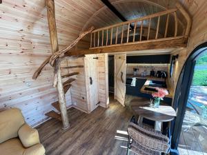 an interior view of a tiny house with a table at Scranton luxury fishing pod with private fishing Jetty in Spilsby