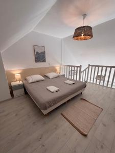 a bedroom with a large bed with two pillows at Ti Mad, Echappée belle à La Baule - mer et piscine in Guérande