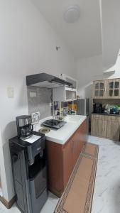 a kitchen with a stove and a counter top at City View Studio Pool - Gym - Caesar Residence in Mactan Island