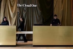 a man and woman standing behind a table with at The Cloud One Wien-Staatsoper in Vienna