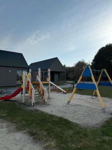 a group of playground equipment in a park at Navi Jūra House13 in Palanga