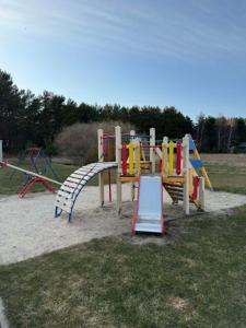 a group of playground equipment in a park at Navi Jūra House13 in Palanga +8 photos