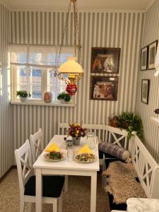 a dining room with a white table and chairs at Fyrås Gård Tallstugan in Fyrås