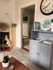a living room with a clock on the wall at Fyrås Gård Tallstugan in Fyrås