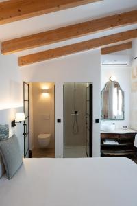 a bedroom with a bed and a bathroom with a shower at Sa Pobla Rooms Ex Flor de Mandarina in Sa Pobla +48 photos