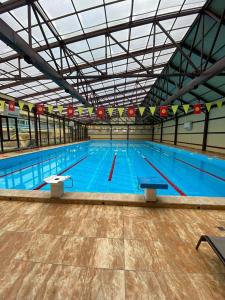 a large indoor swimming pool with a large pool at Нур Срубы Сары Ой in Chon-Sary-Oy